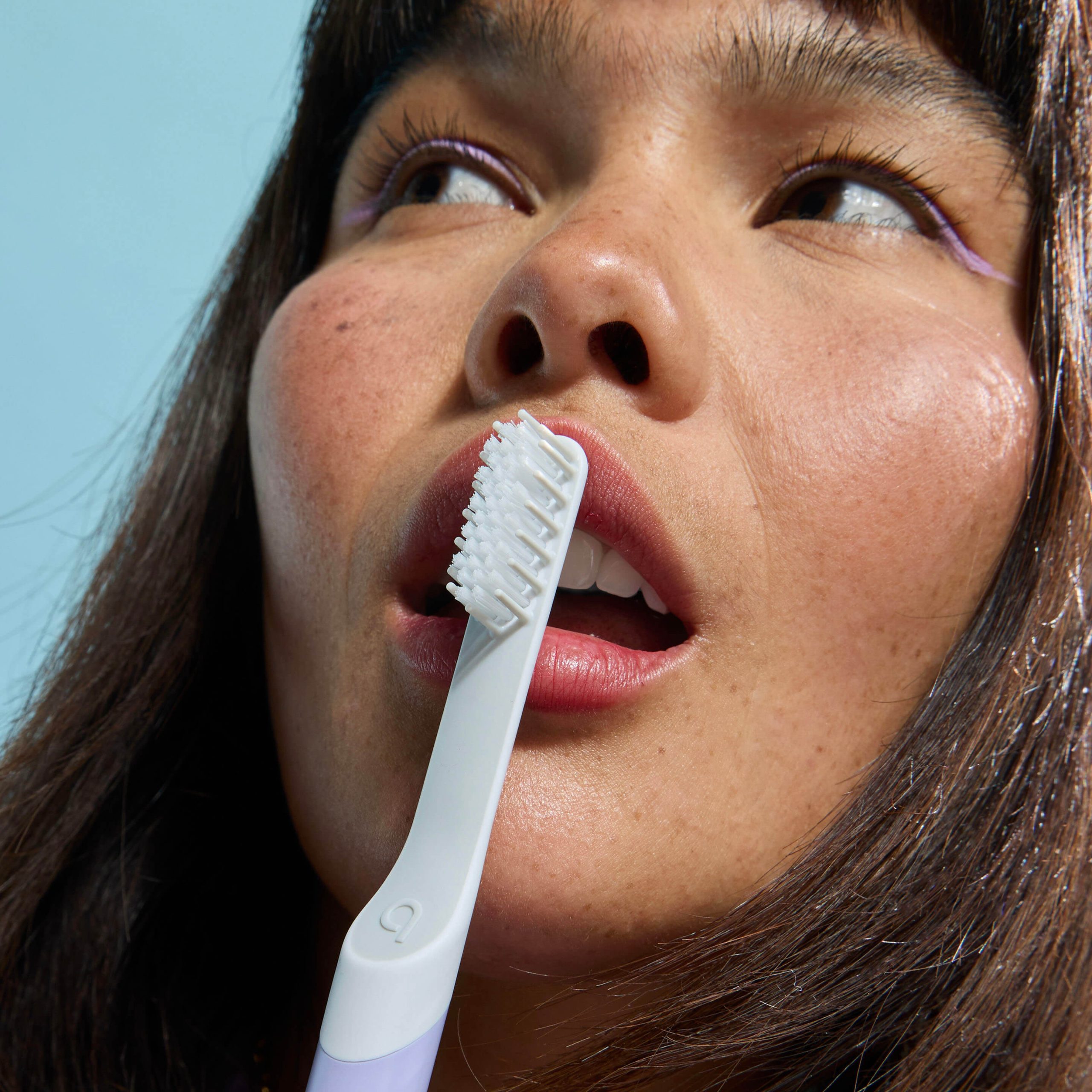 Person brushing teeth with a Quip Sonic Toothbrush