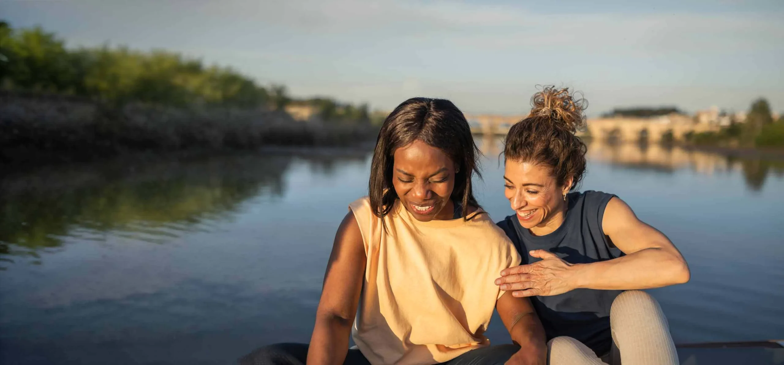 Two women talking outdoors, lifestyle photo from the Maven Clinic website