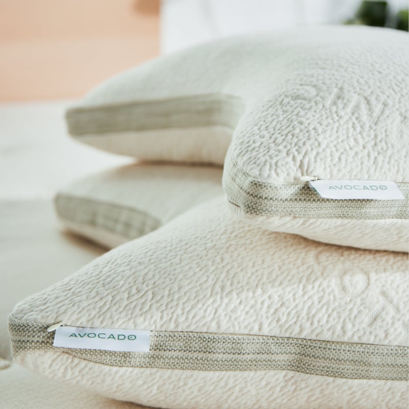 Current official Avocado Green Pillow product photography, pair shown on a bed