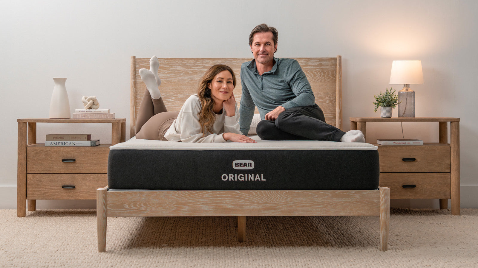 Couple relaxing on a Bear Original mattress, from the Bear Mattress website