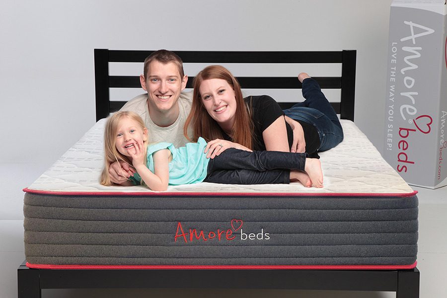 Family lying on an Amore Beds Hybrid mattress, current product photography