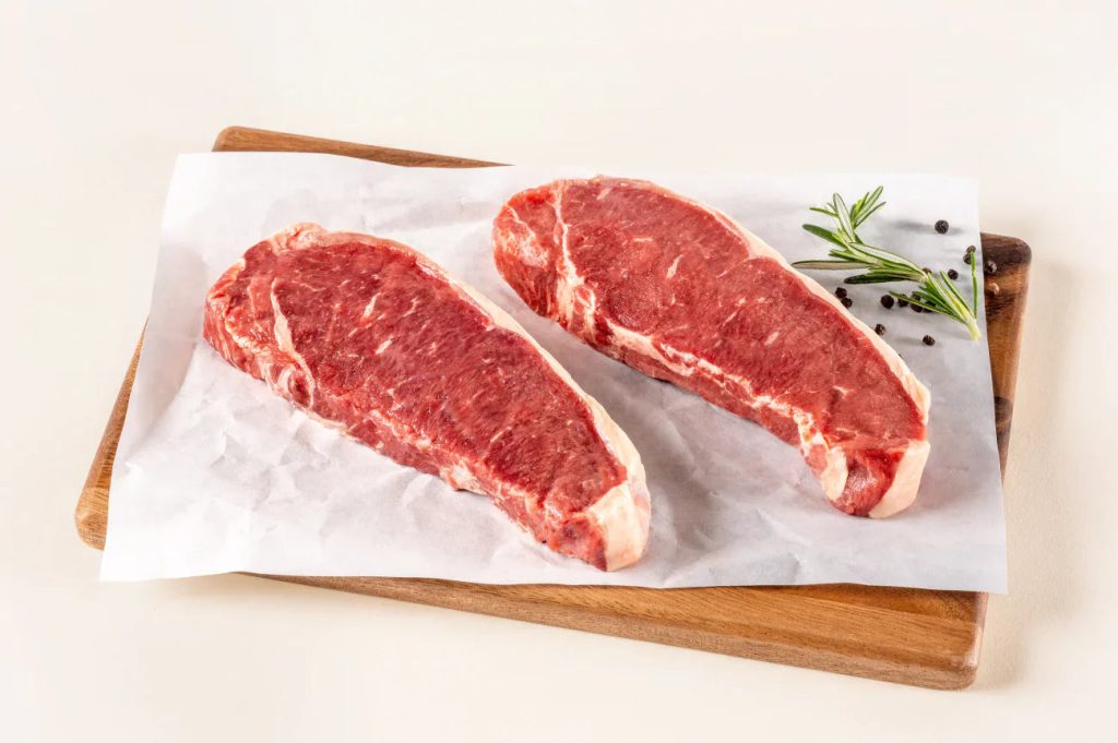 ButcherBox New York strip steaks on a cutting board