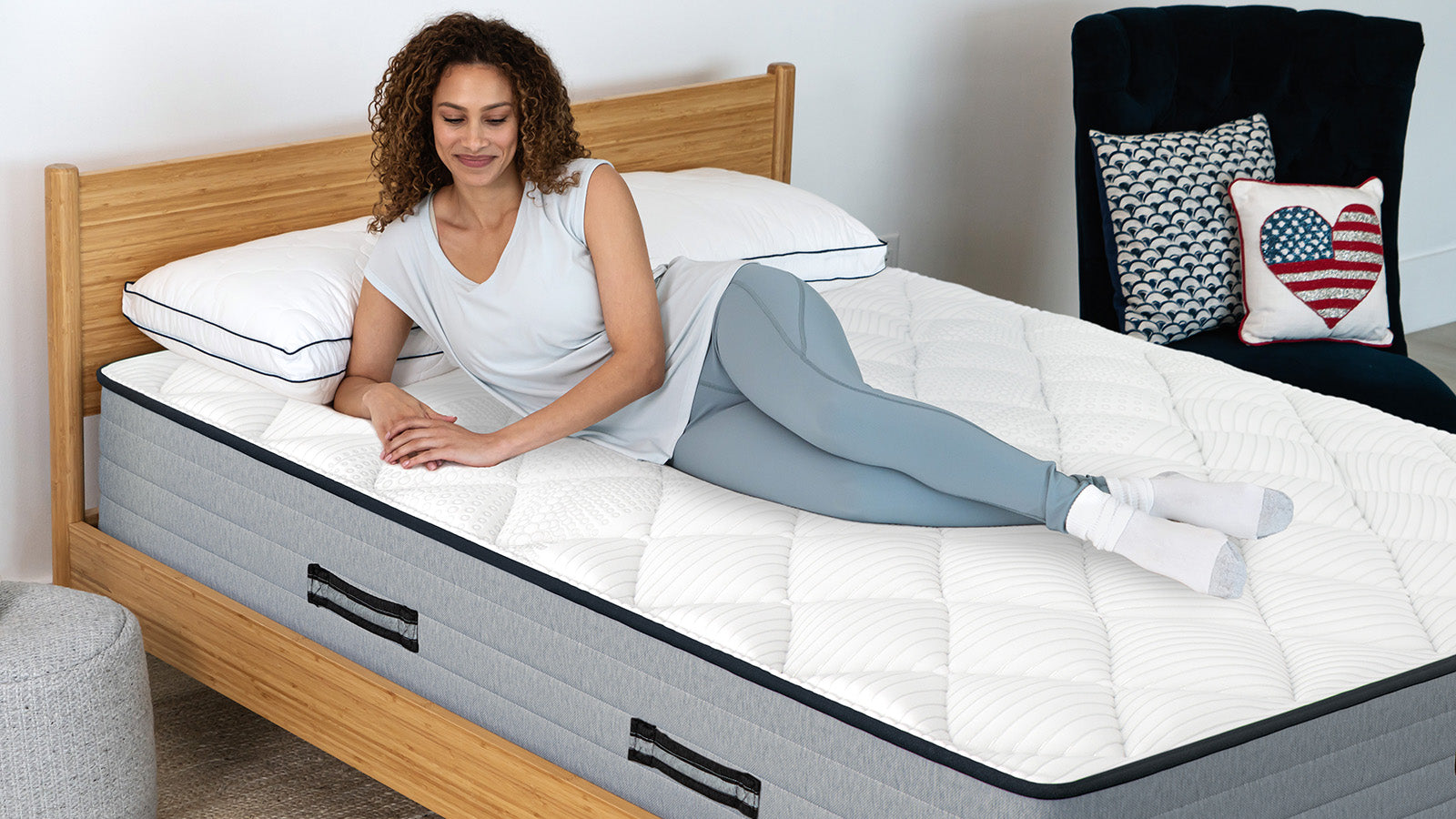 Woman lying on a Bear Pro Hybrid mattress, from the Bear Mattress website