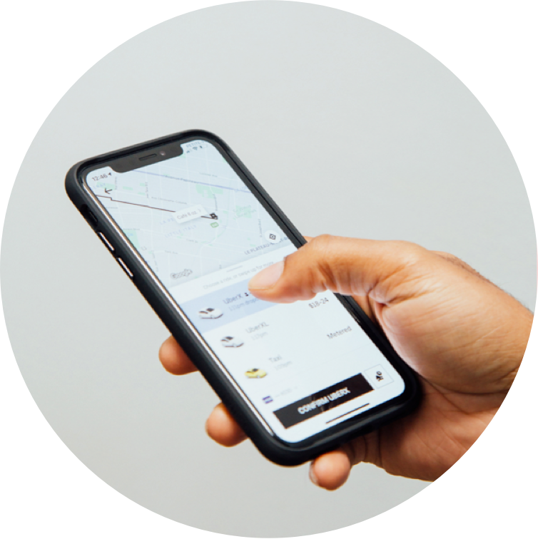 Hand holding a phone showing a ride-booking app screen, from Drop's marketing site illustrating earning points on purchases with partner brands