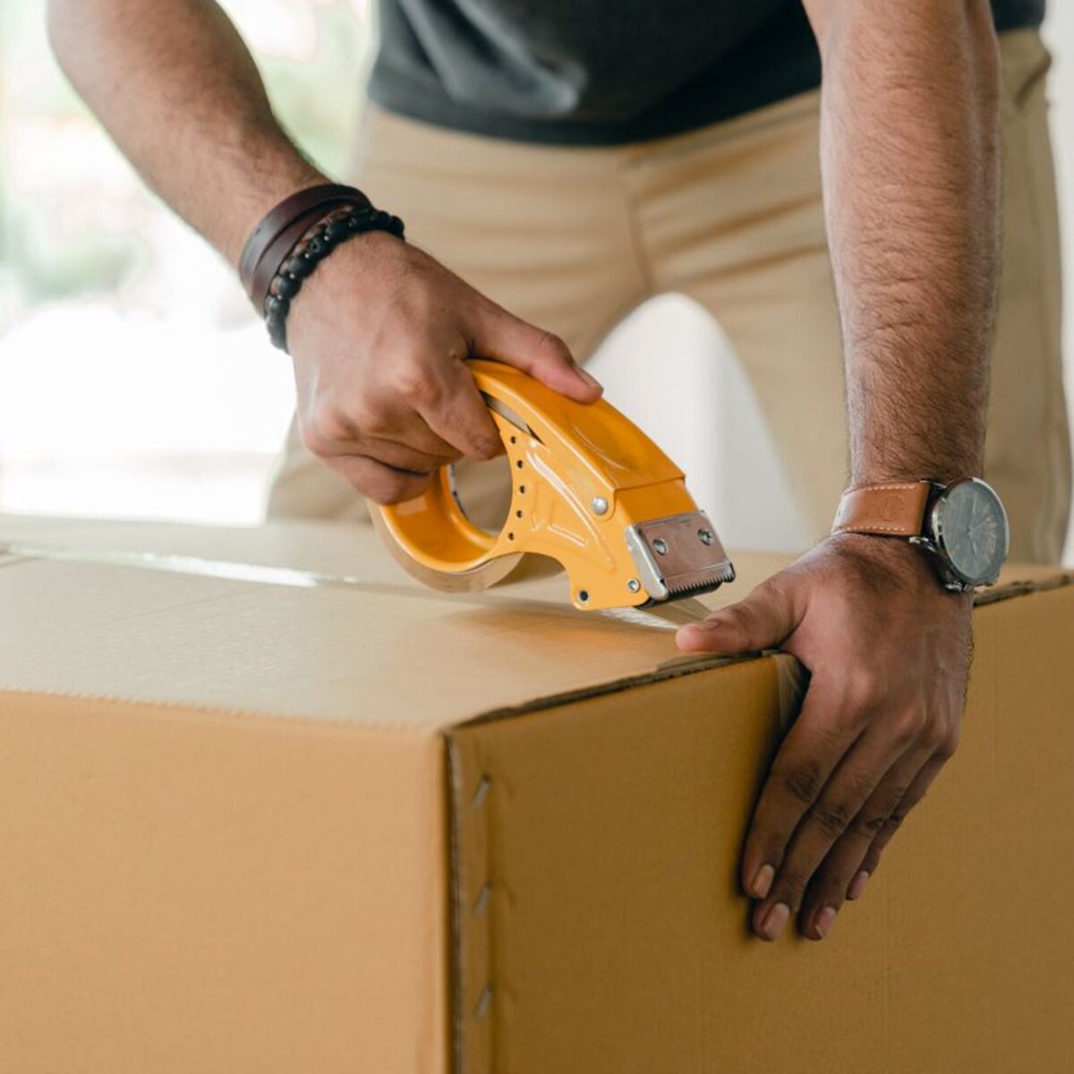 Takl service provider taping a moving box