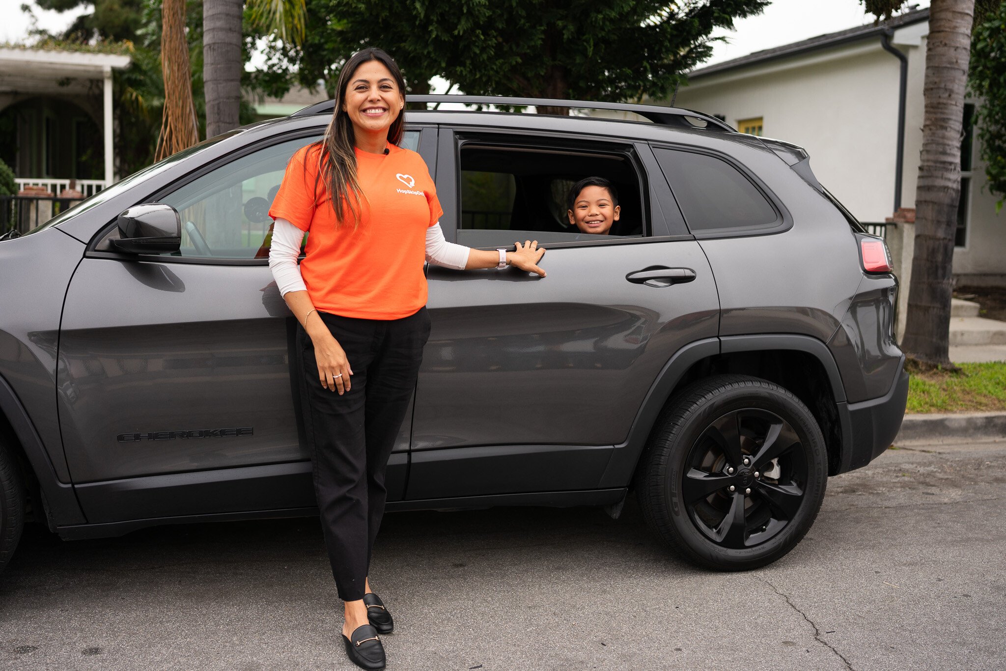 HopSkipDrive caregiver driver with passenger in SUV