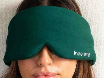 A person wearing the green Innerwell eye mask during an at-home ketamine therapy session
