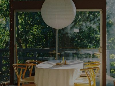 A sunlit dining table and garden doors inside a member home on the Kindred home swapping network