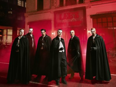 The six actors who play the Phantom in Masquerade, in capes and half-masks, outside the old Lee's Art Shop on West 57th Street in New York