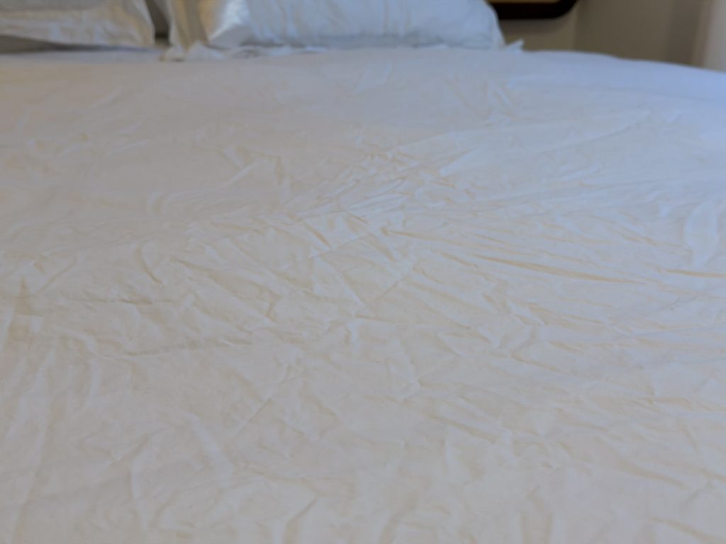Close-up of the Prossioni percale duvet cover after washing, showing a light, crinkled matte texture